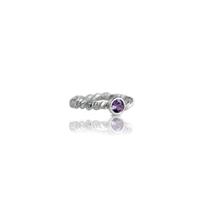 Silver ring with amethyst on white background