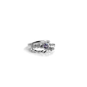 Entwined Gemstone ring with amethyst and 2 side bands on white background
