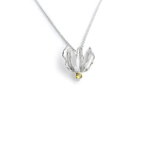 Silver flame lily pendant with citrine gemstone on chain. White background