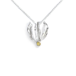 Silver flame lily pendant with citrine gemstone on chain. White background