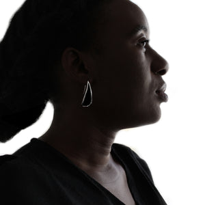 Silver loop earrings on white background