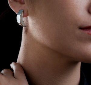 Silver comfy Stud earrings on model with black Background