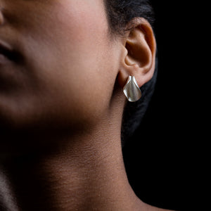 Silver Pod studs on a model. black background