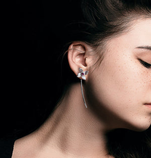 Flower studs on a woman black background