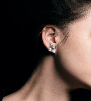 Flower studs on a woman black background