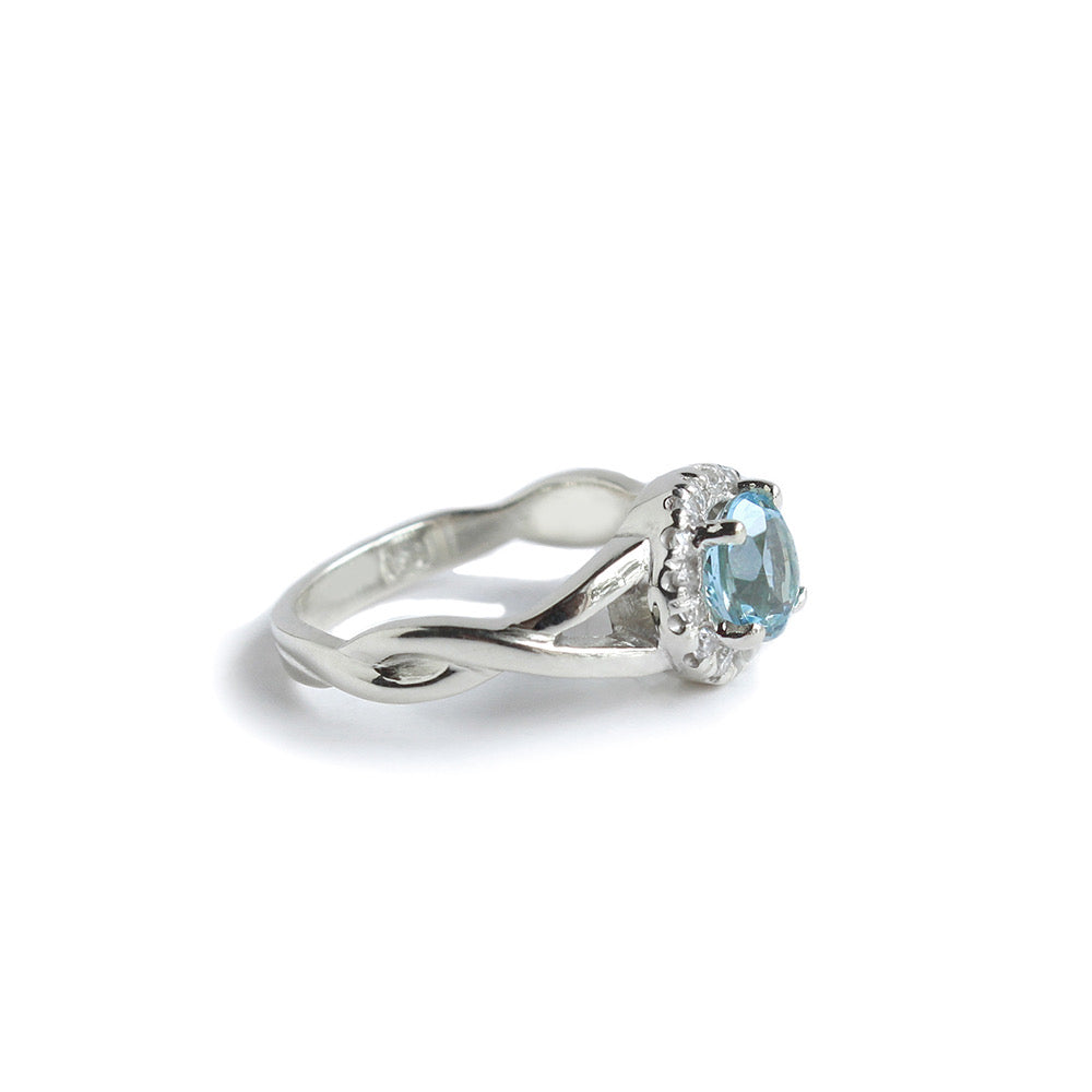 Halo engagement ring with claw set Aquamarine and Diamonds