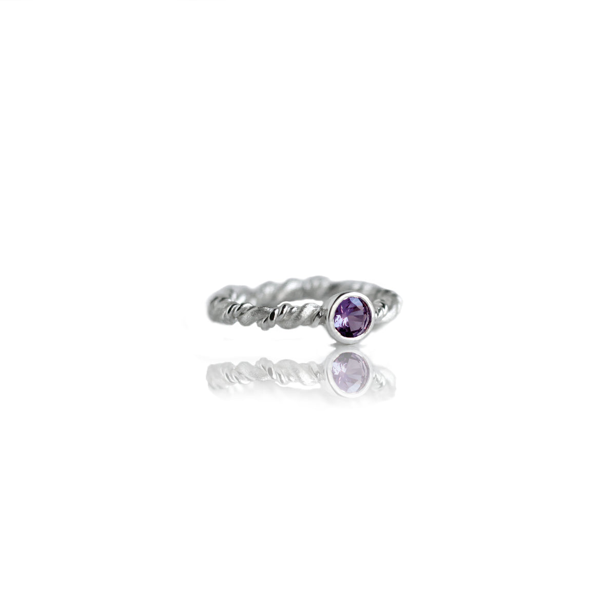 Silver ring with amethyst on white background