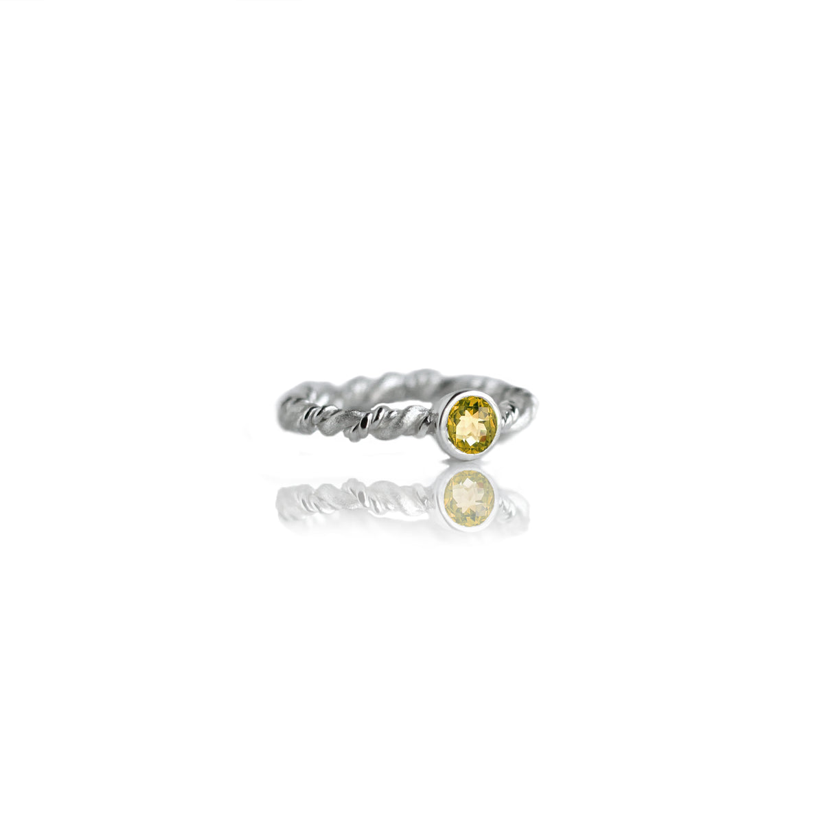 Silver ring with citrine on white background