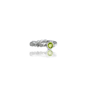 Silver ring with peridot on white background