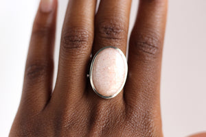 Peach Moonstone Ring on hand. white background