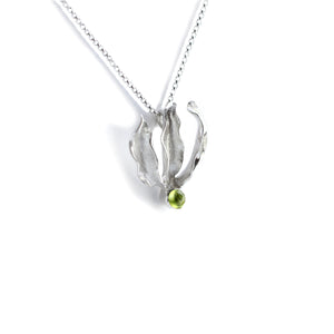 Silver flame lily pendant with peridot gemstone on chain. White background