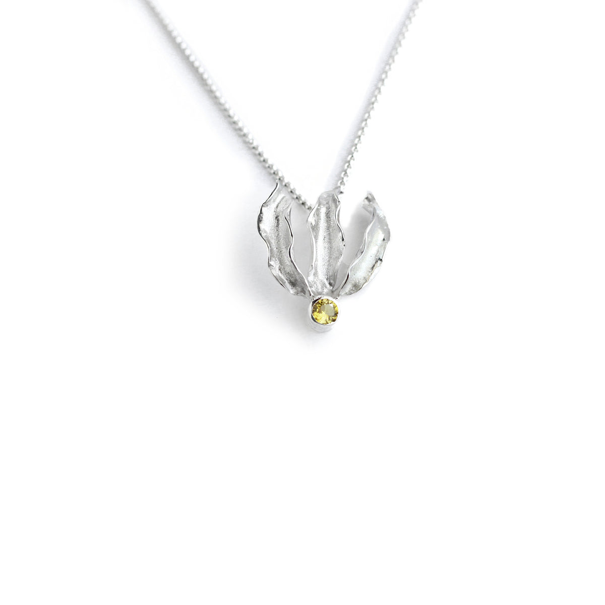 Silver flame lily pendant with citrine gemstone on chain. White background