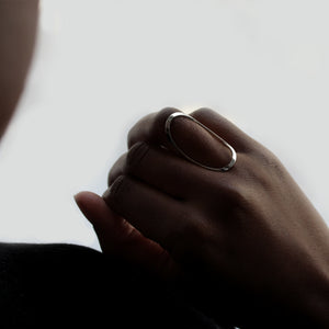 Close-up of Oval ring on model's hand. 