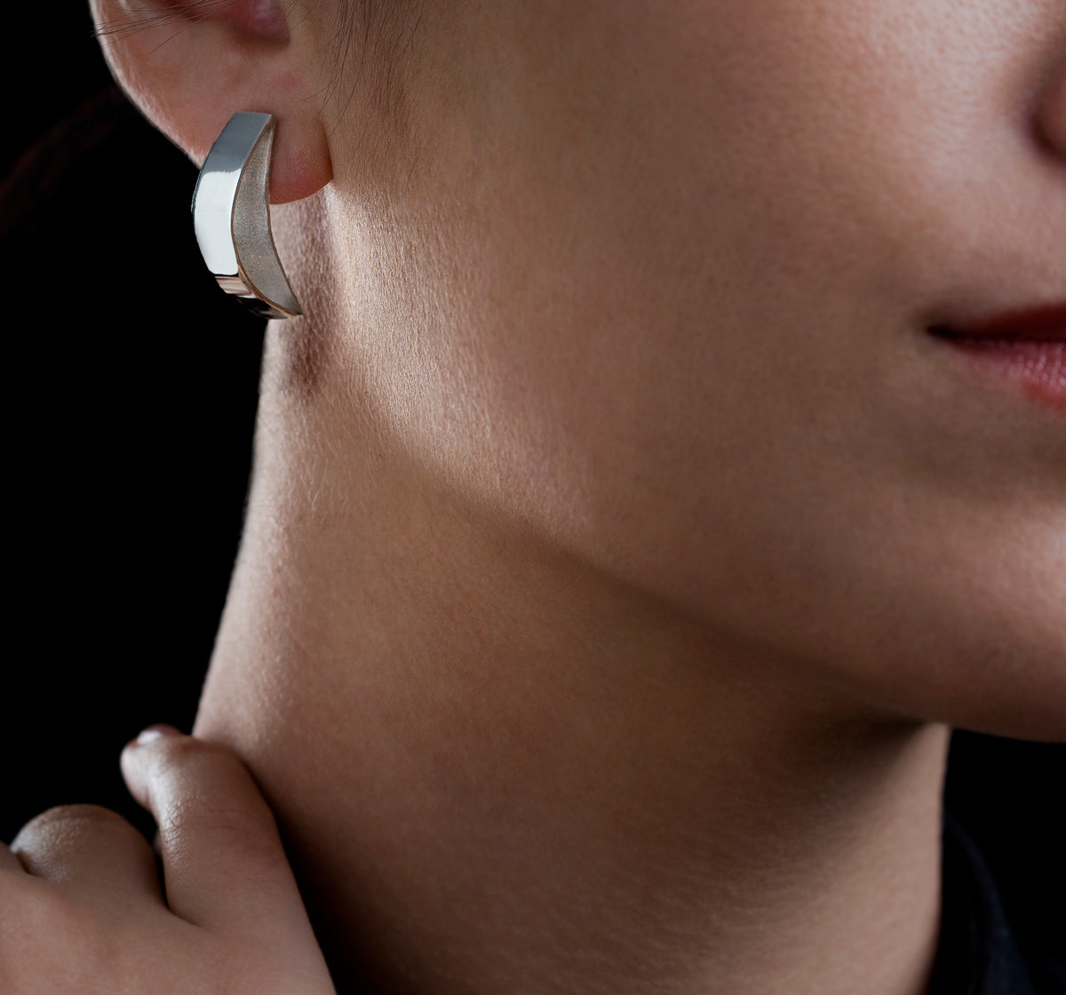 Silver comfy Stud earrings on model with black Background