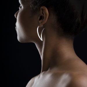 Woman wearing Curvy V shape earring. Sideview