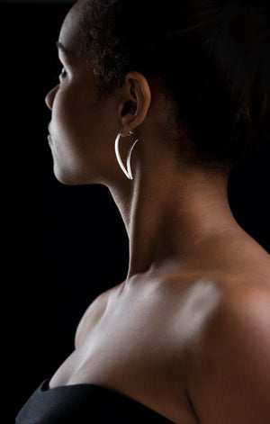 Woman wearing Curvy V shape earring. Sideview