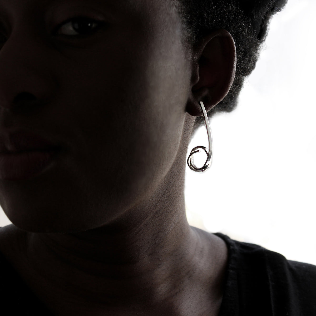 Long silver Loop stud on model white background. 