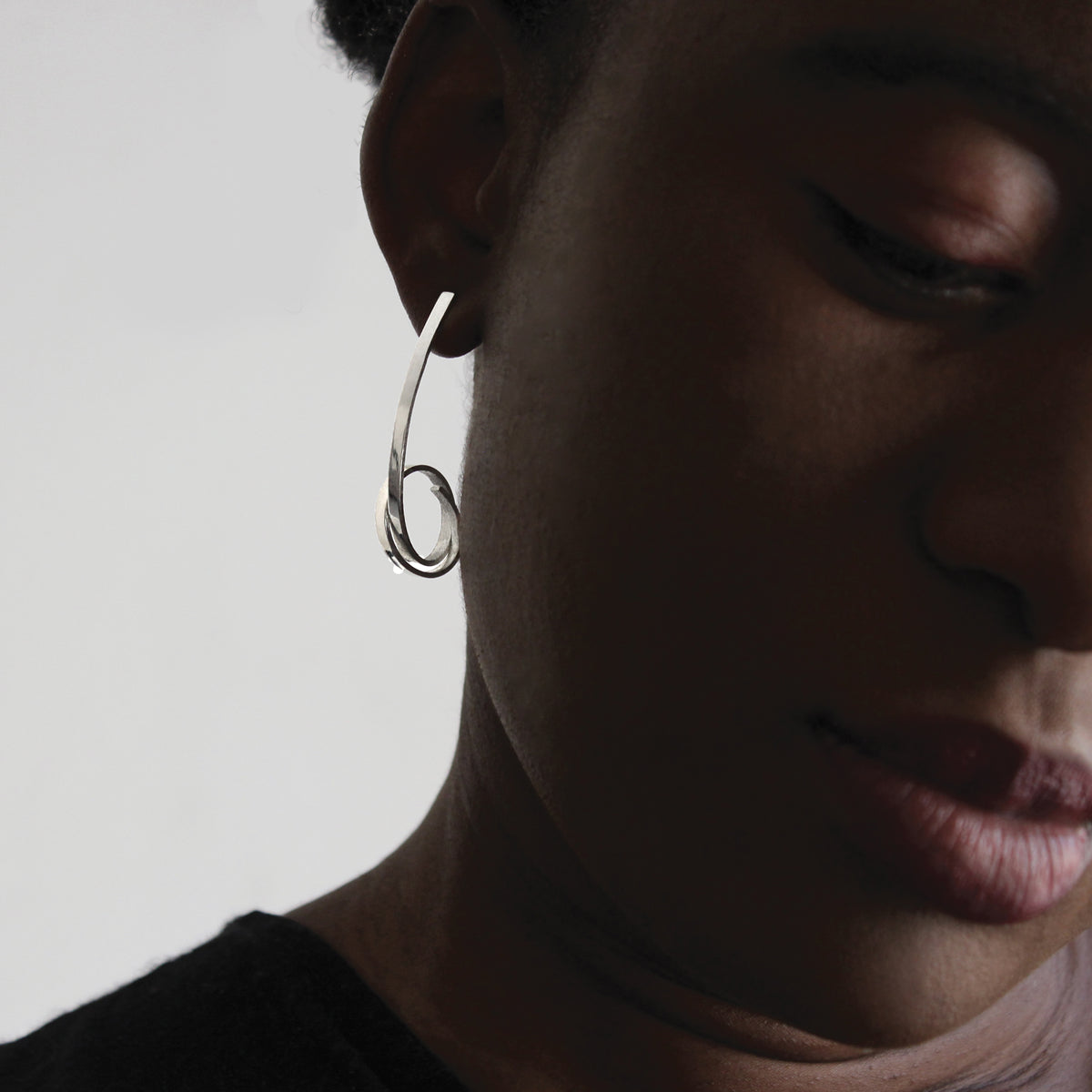 Long silver Loop stud on model white background. 