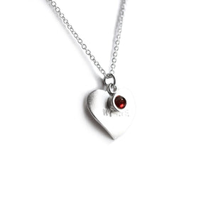Silver heart on chain with engraved date and red garnet on top